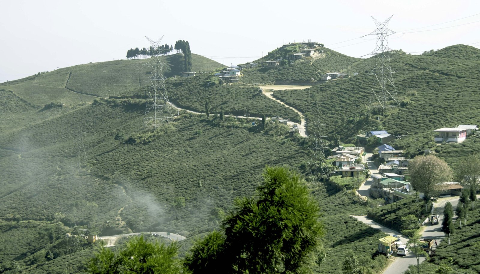 a scenic view of a village on a hill